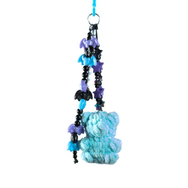 Light blue crochet gummy bear keychain on a beaded chain of purple and black bats and stars