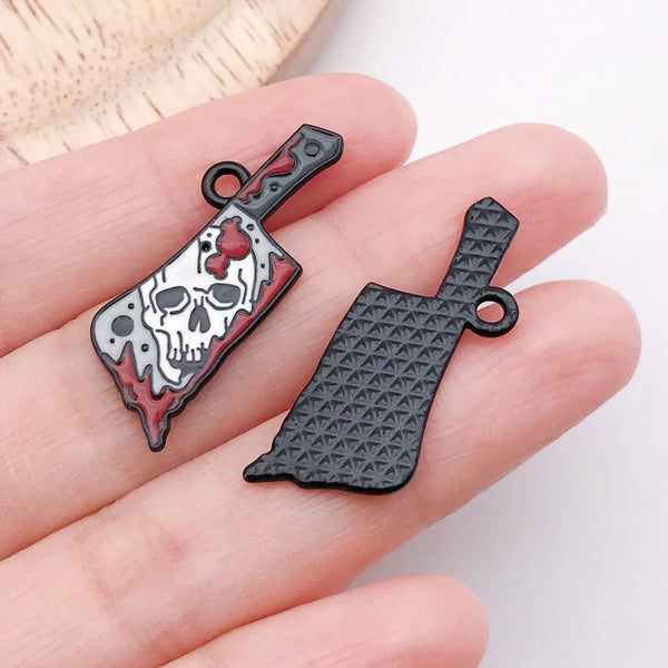 Black enamel blade charm with a white skull