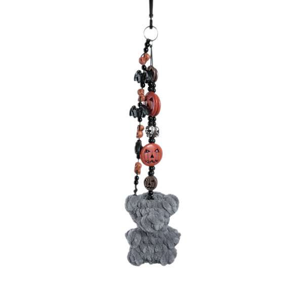 Gray crochet gummy bear keychain on a beaded chain of orange jack-o'-lanterns, black bats, and white skulls
