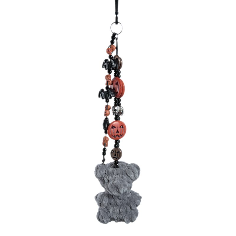 Gray crochet gummy bear keychain on a beaded chain of orange jack-o'-lanterns, black bats, and white skulls
