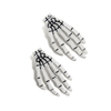 Glow-in-the-dark skeleton hand hair clip pair, shown glowing