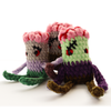 Three hand-crocheted zombie plushies grouped together